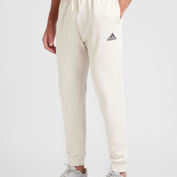 Cumpăra ADIDAS SPORTSWEAR Pantaloni sport 'Essentials'  bej deschis / negru