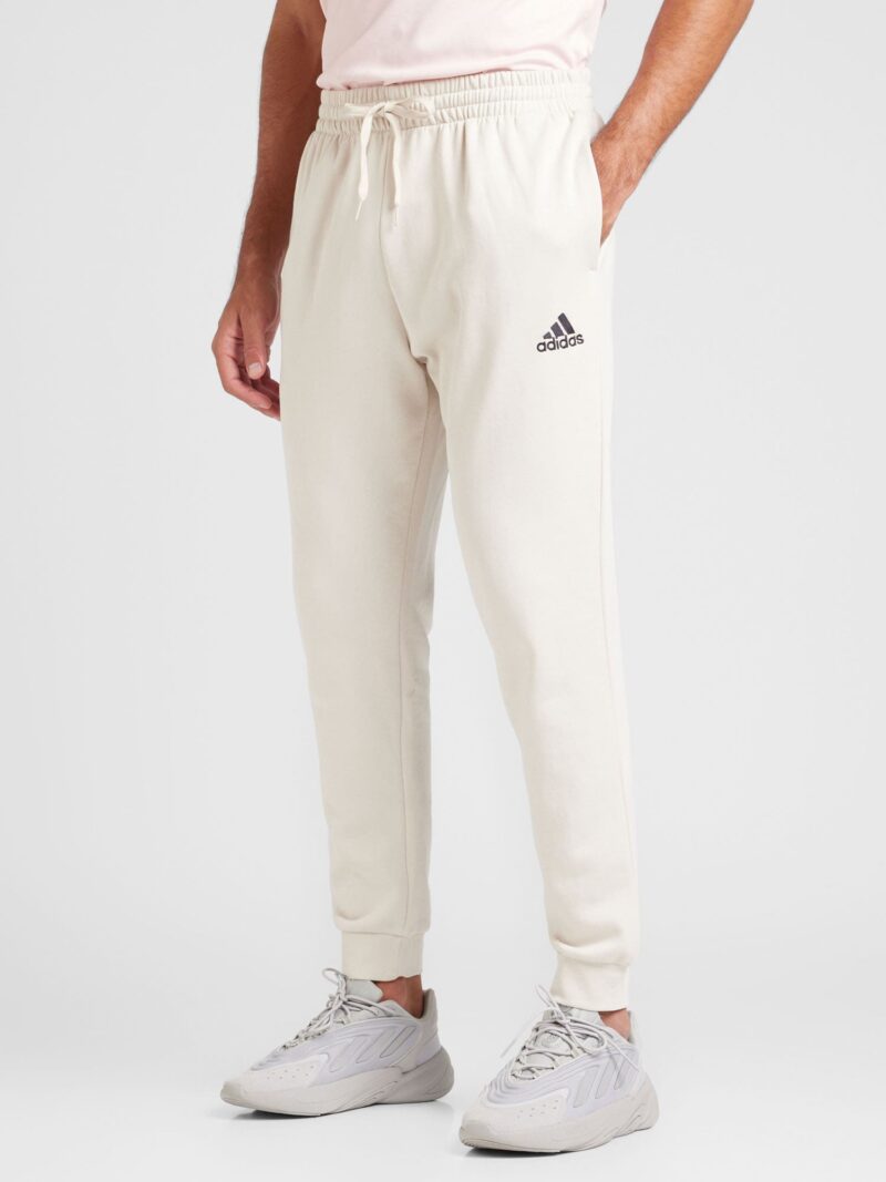 Cumpăra ADIDAS SPORTSWEAR Pantaloni sport 'Essentials'  bej deschis / negru