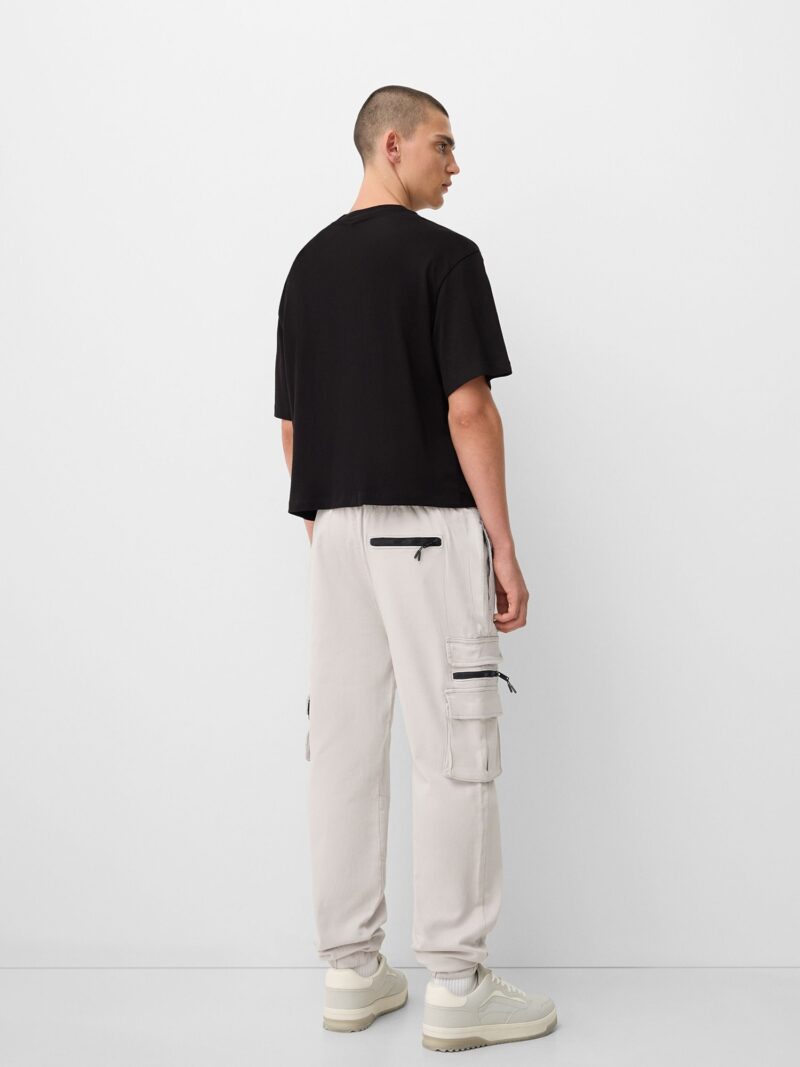 Bershka Pantaloni cu buzunare  gri deschis / negru preţ