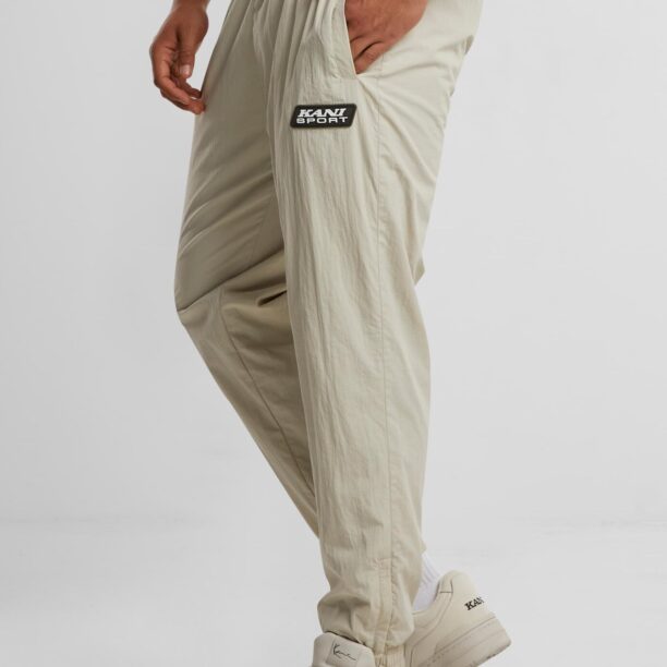 Cumpăra Karl Kani Pantaloni sport 'Patch Essential'  bej / nisipiu