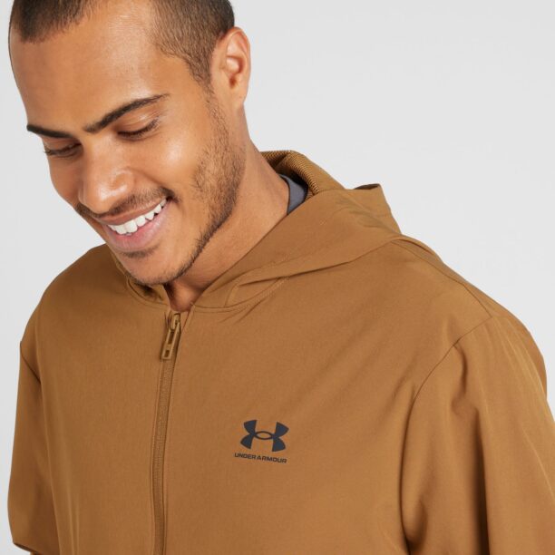 Cumpăra UNDER ARMOUR Geacă sport 'Vibe'  maro caramel / negru